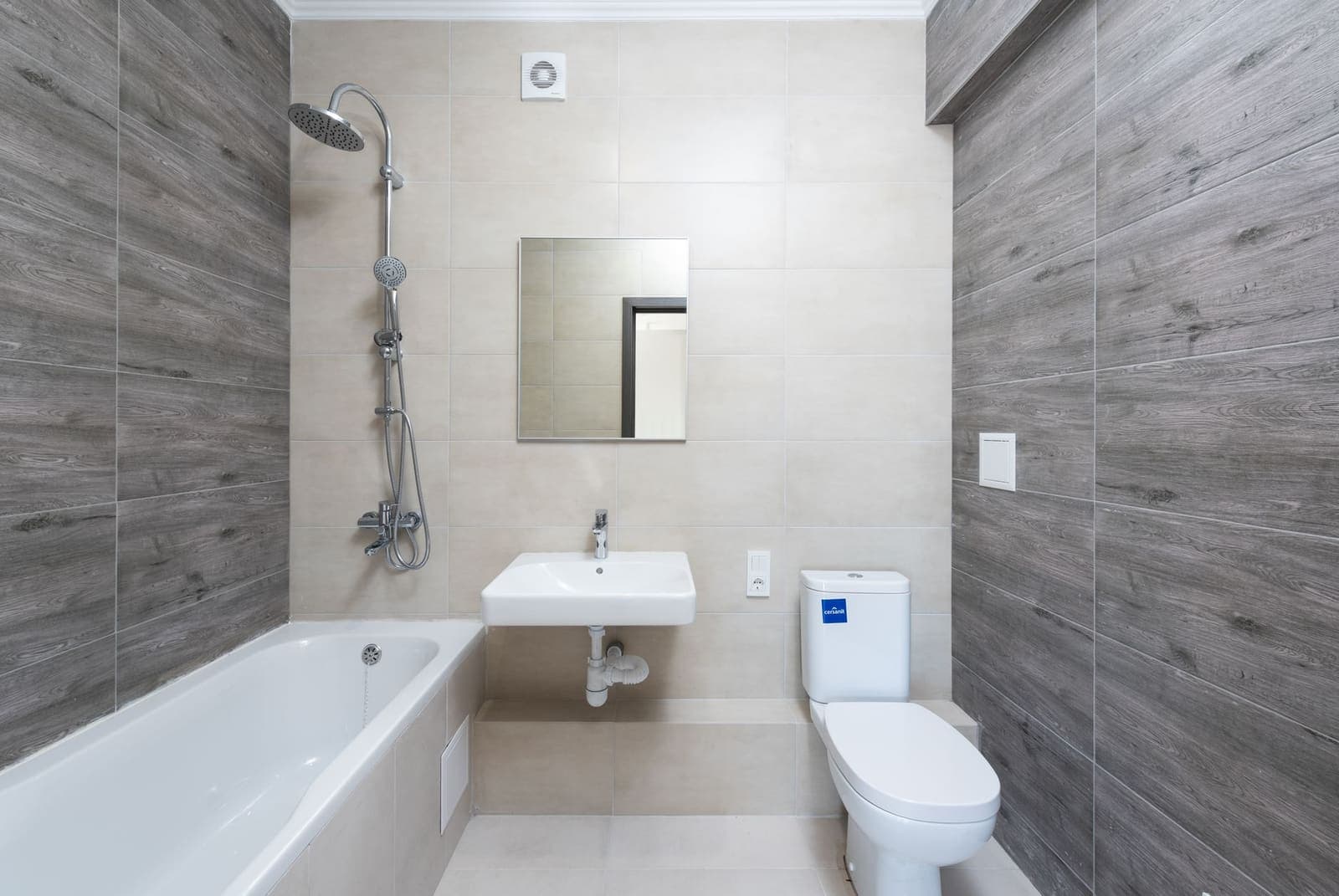 Bathroom with a tub, sink and exposed fixture plumbing in a DeSoto, Texas home.