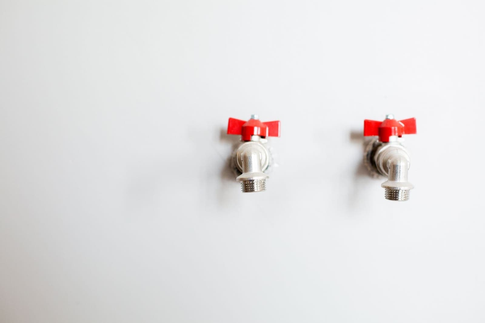 Wall-mounted faucets and exposed supply connections in a Little Elm, Texas home.