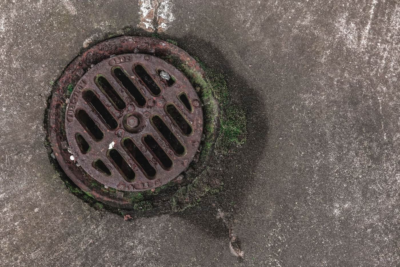 Sewer cleanout cap set into the ground outside a Rowlett, Texas home.