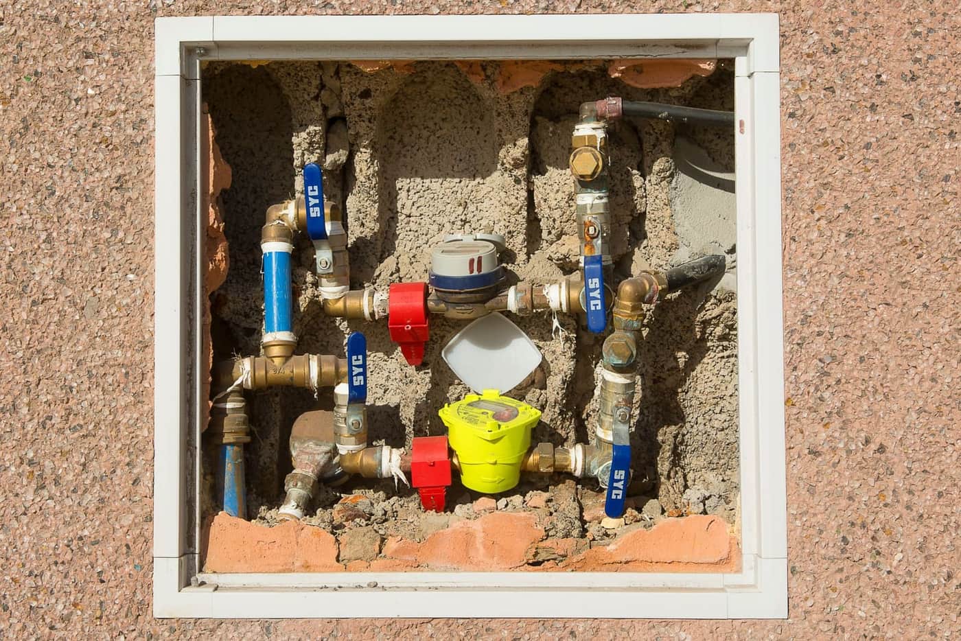 A residential water meter set in concrete, the first tool for confirming a hidden water leak